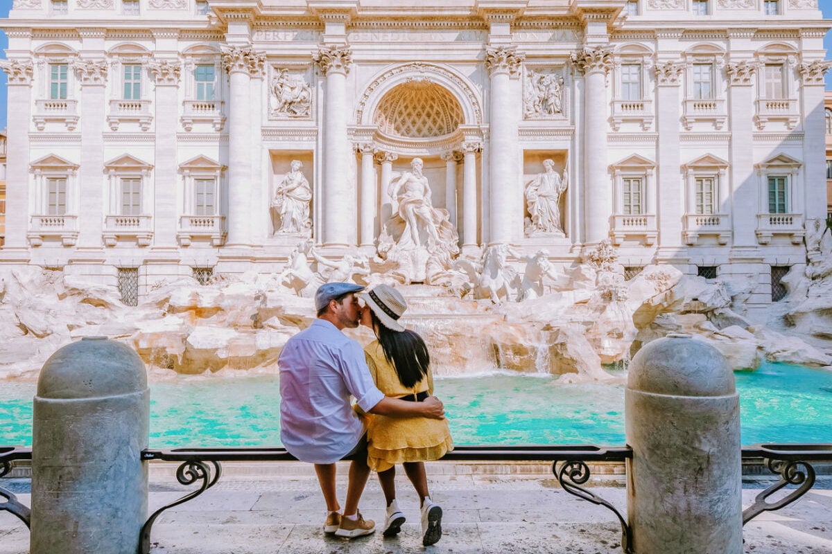 Couple posing at Rome's Trevi Fountain