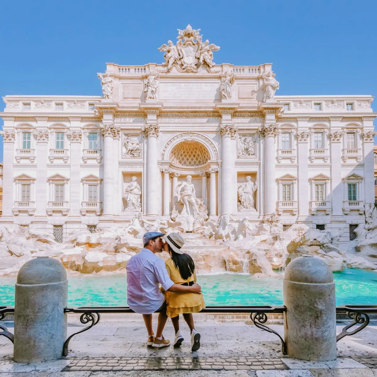 Couple posing at Rome's Trevi Fountain