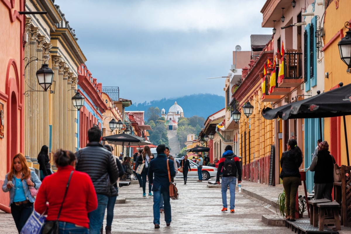 San Cristóbal de las Casas Typical street of the highland town with colourful colonial architecture, narrow cobblestone streets and the Church of Our Lady of Guadalupe on hilltop
