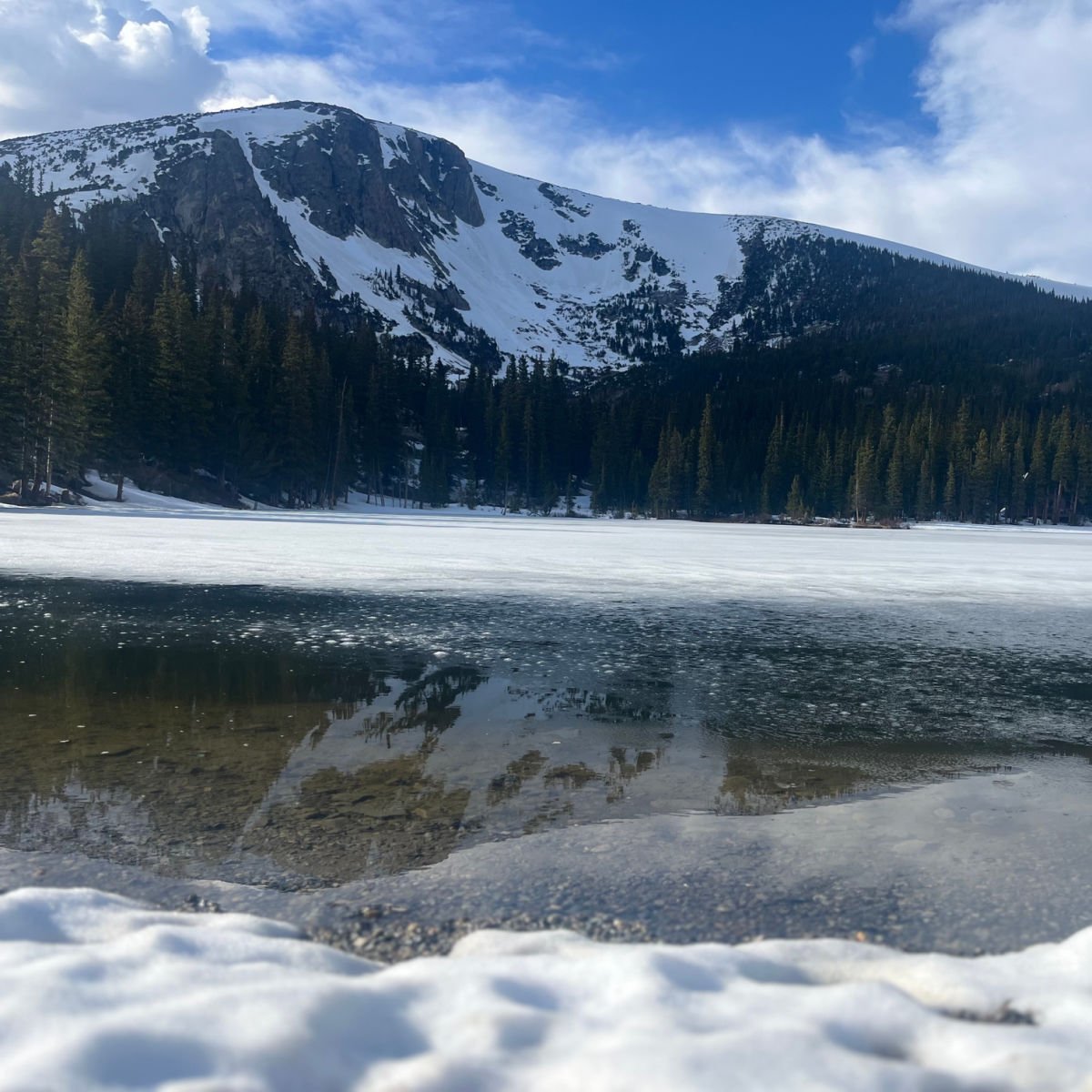 Snow-covered mountains and alpine lake in Idaho Springs, CO