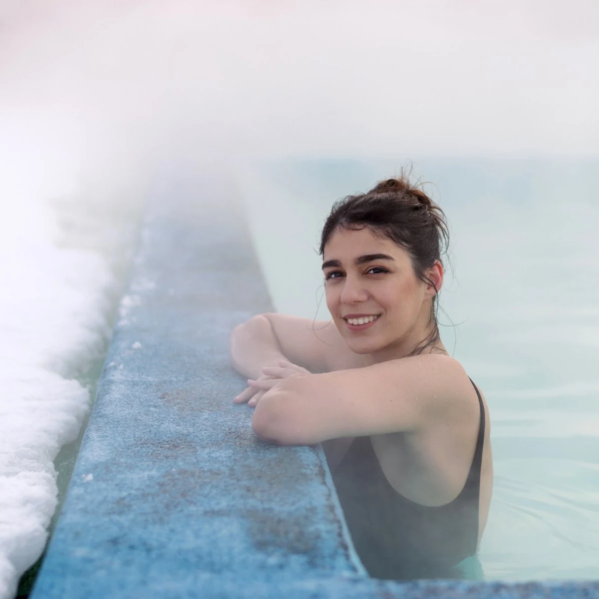 Woman soaking in geothermal waters