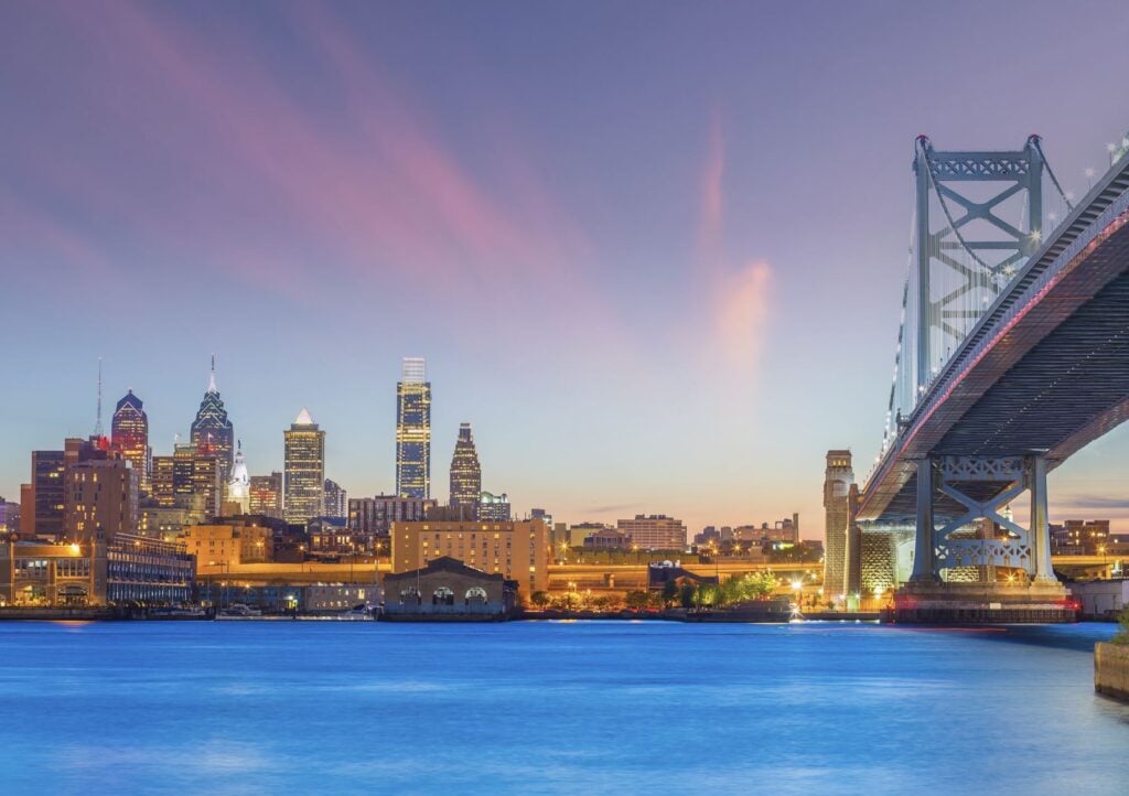Downtown Philadelphia city skyline, cityscape of Pennsylvania in USA with Ben Franklin Bridge at sunset
