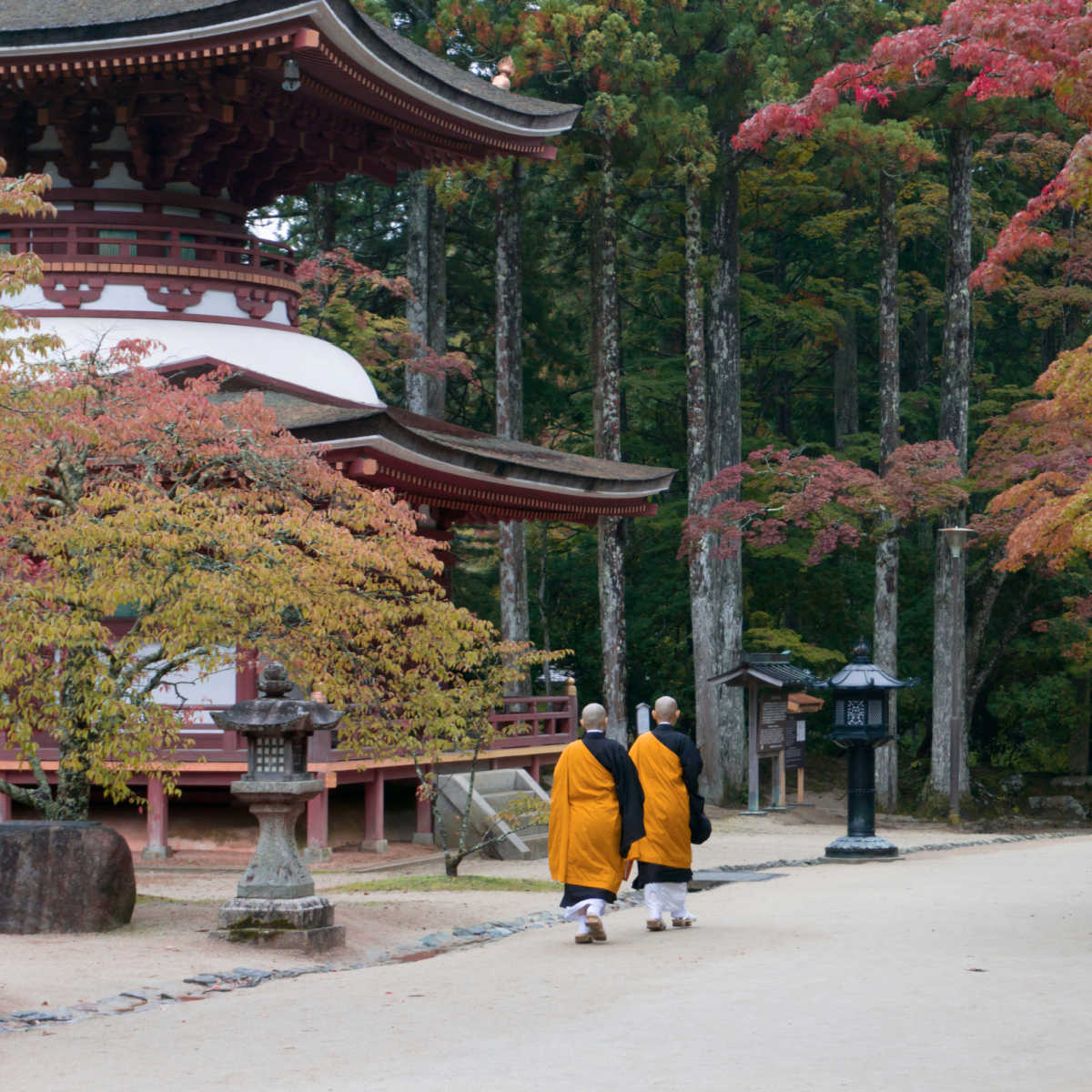 Buddhist monks walking past temple in Koyasan