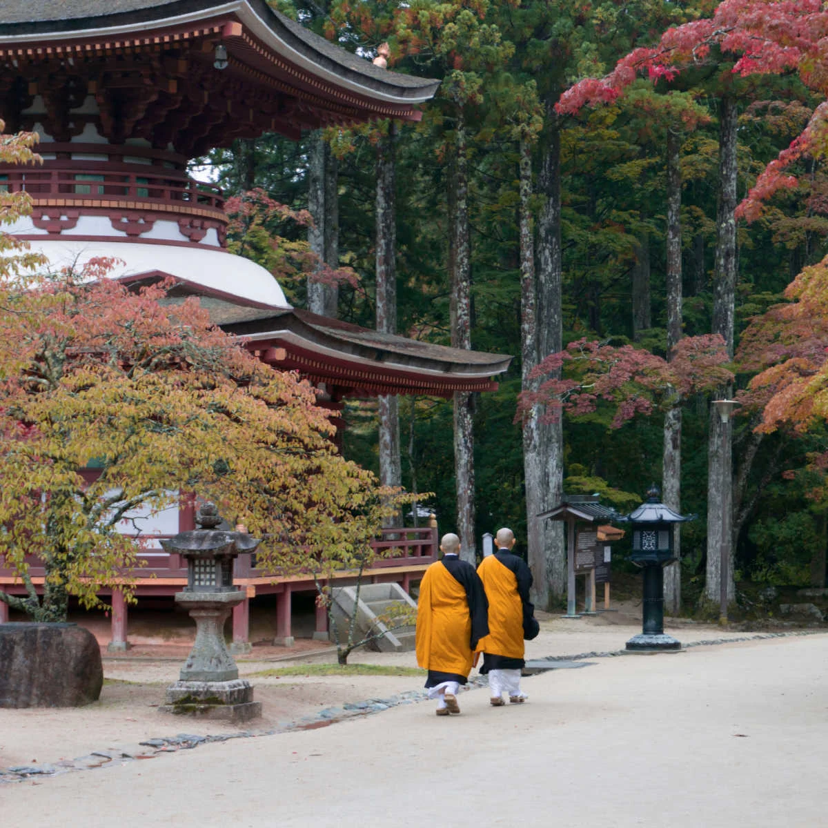 Buddhist monks walking past temple in Koyasan