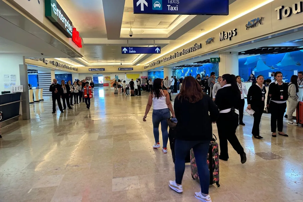 Cancun Airport Shark Tank, woman walking to the exit with timeshare person following her