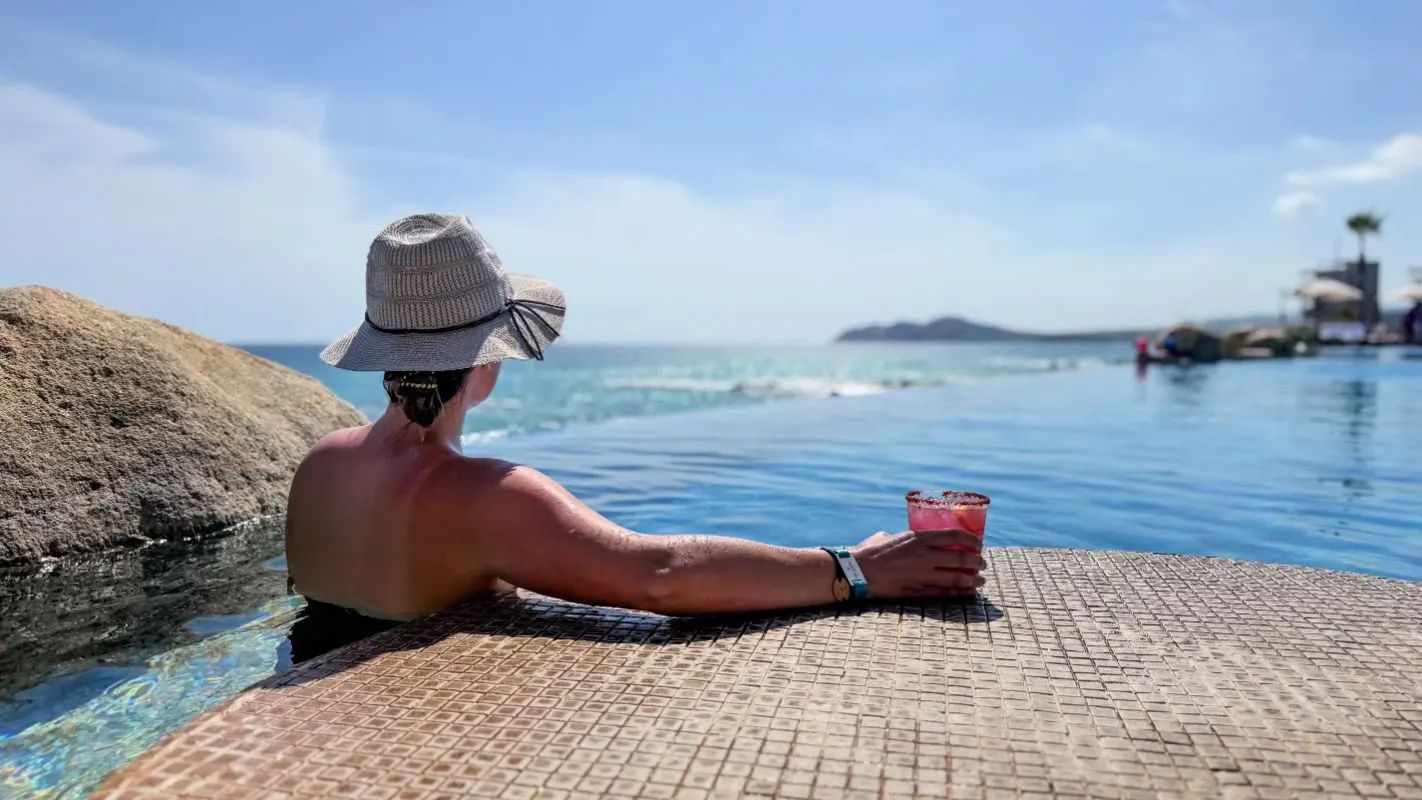 Woman sitting in the pool at Villa La Valencia in Los Cabos