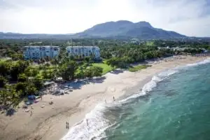 Aerial view of Puerto Plata beach, drone shot from Tyler Fox Managing Editor, people walking along Dominican Republic beach