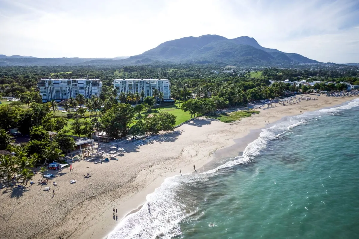 Aerial view of Puerto Plata beach, drone shot from Tyler Fox Managing Editor, people walking along Dominican Republic beach