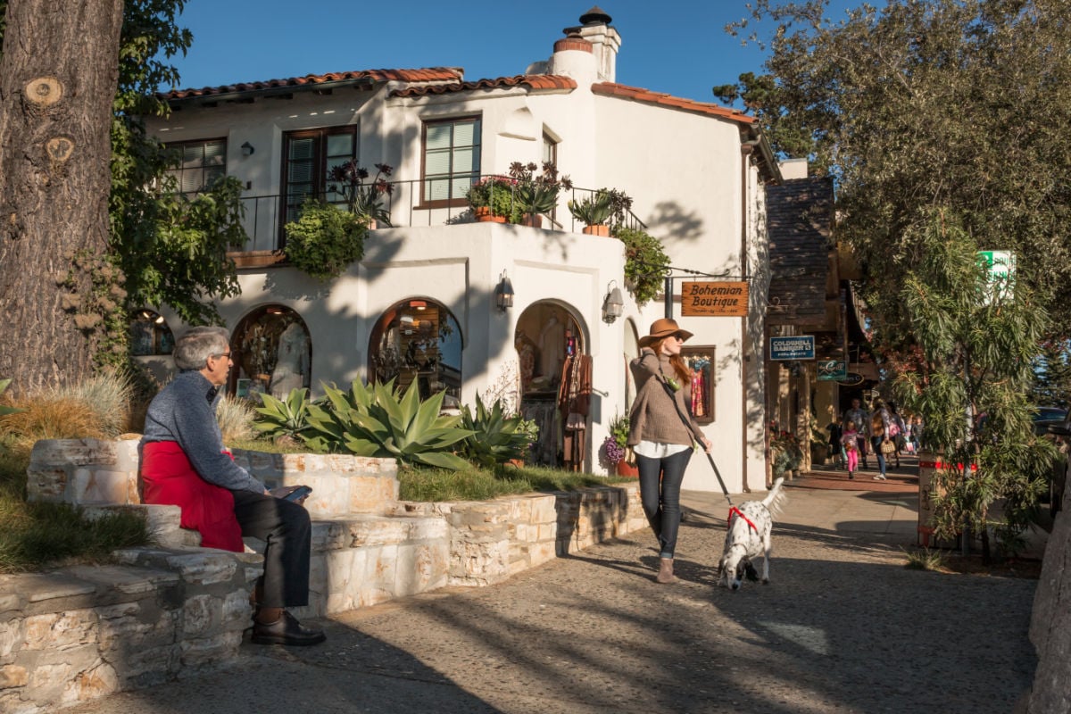 CARMEL-BY-THE-SEA, CALIFORNIA, UNITED STATESA fashionably-dressed, tall and slender woman strolls down a sidewalk in Carmel on a November afternoon.