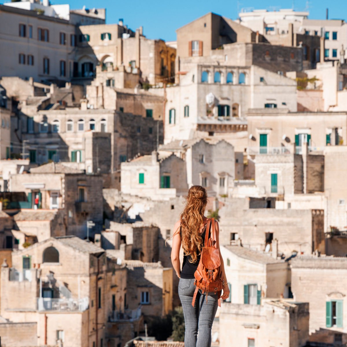 Female tourist visiting historic city of Matera, Italy