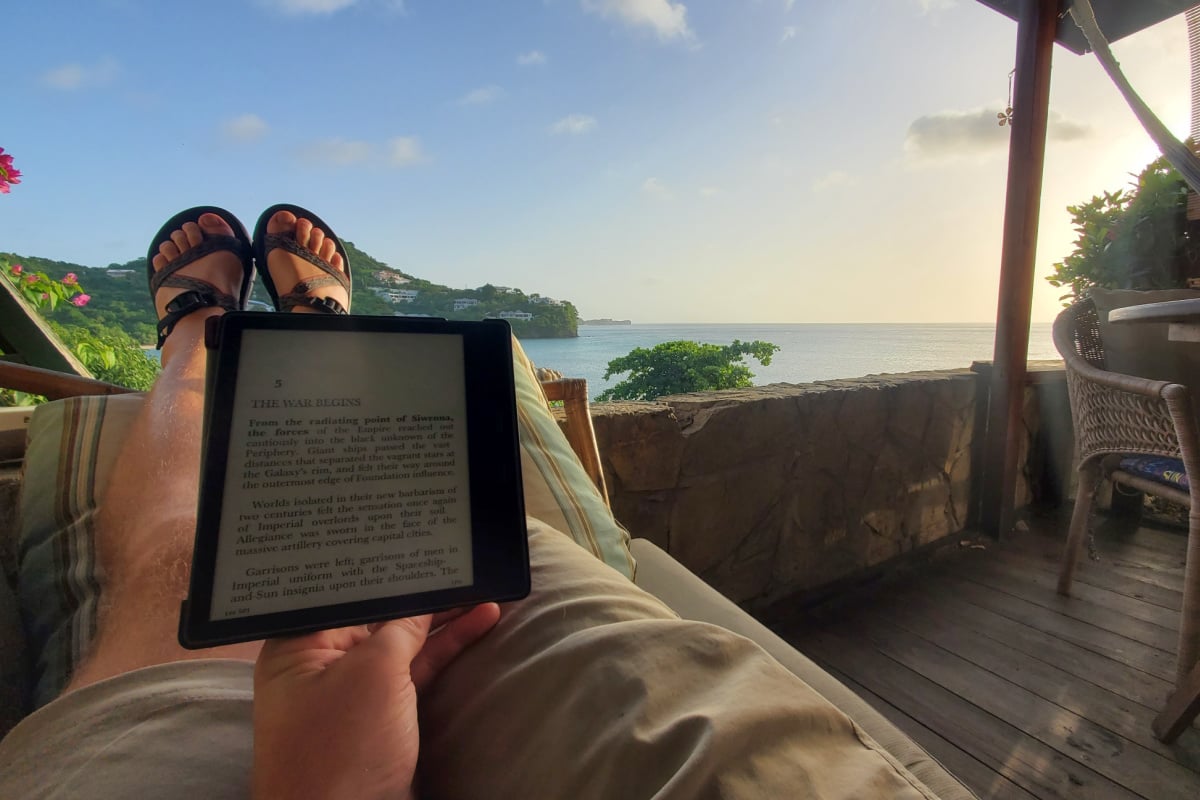 Front porch overlooking BBC beach in Grenada with Tyler Fox reading kindle book