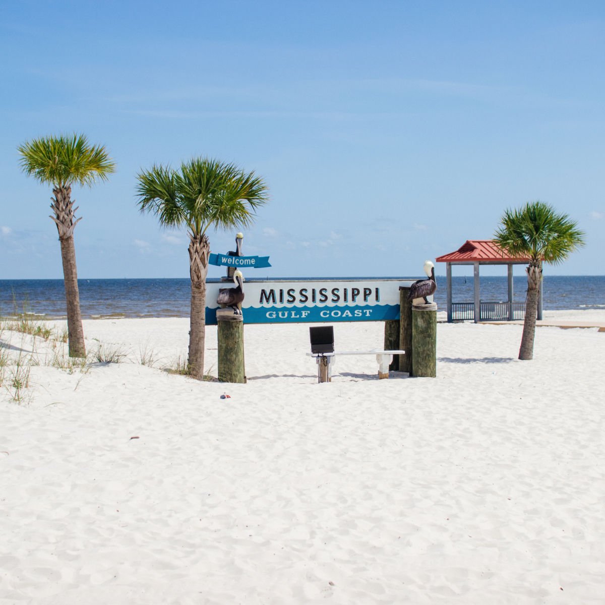 Mississippi Gulf Coast sign on white-sand beach in Gulfport