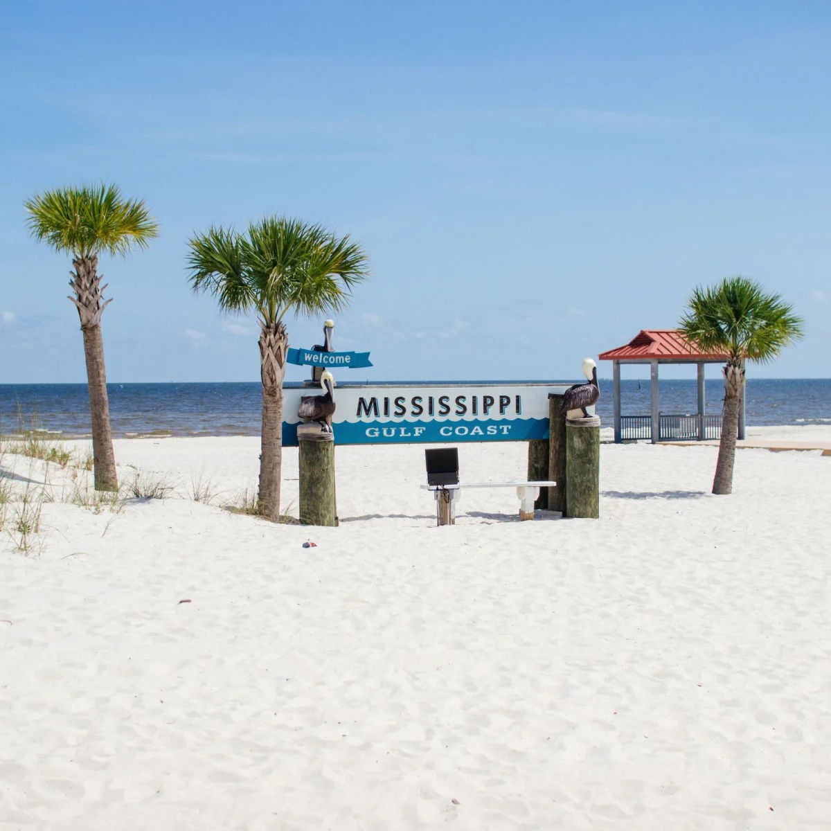 Mississippi Gulf Coast sign on white-sand beach in Gulfport