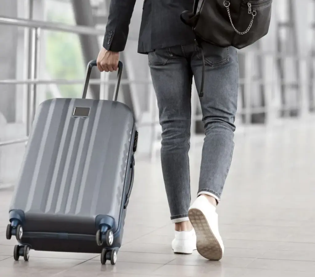Travelers-pulling-luggage-in-airport