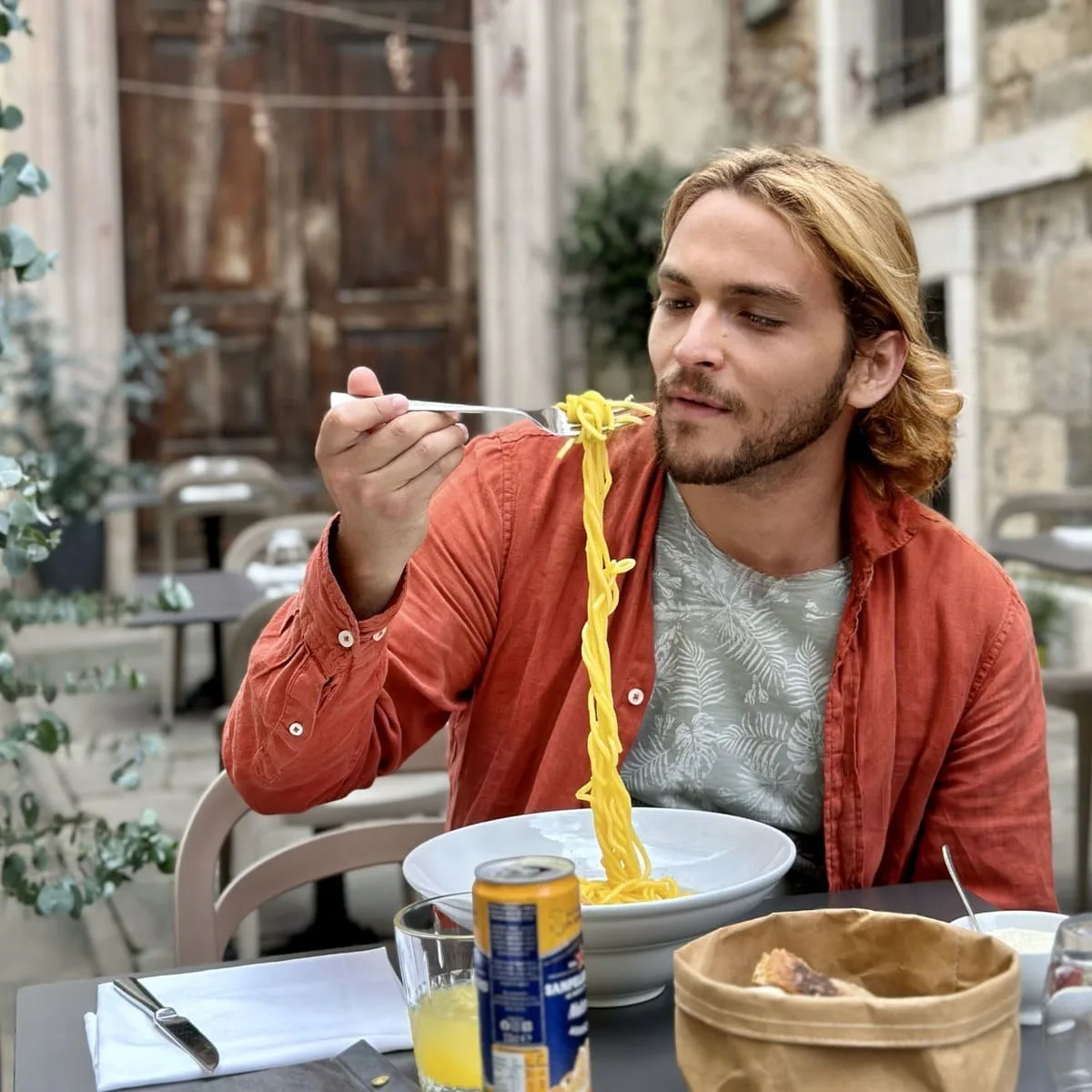 Young Tourist Eating Pasta In Bergamo, Italy