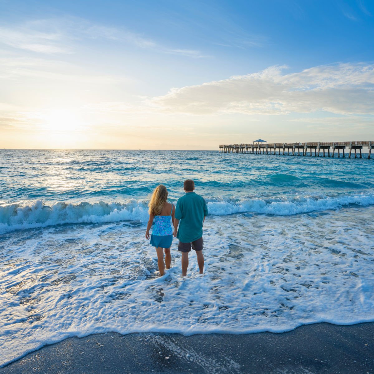 Couple walking on beach in Juno Beach, FL
