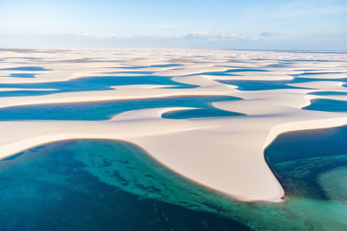Drone shot of fresh rain water lagoons with white sand at Lençóis maranhenses national park in Brazil