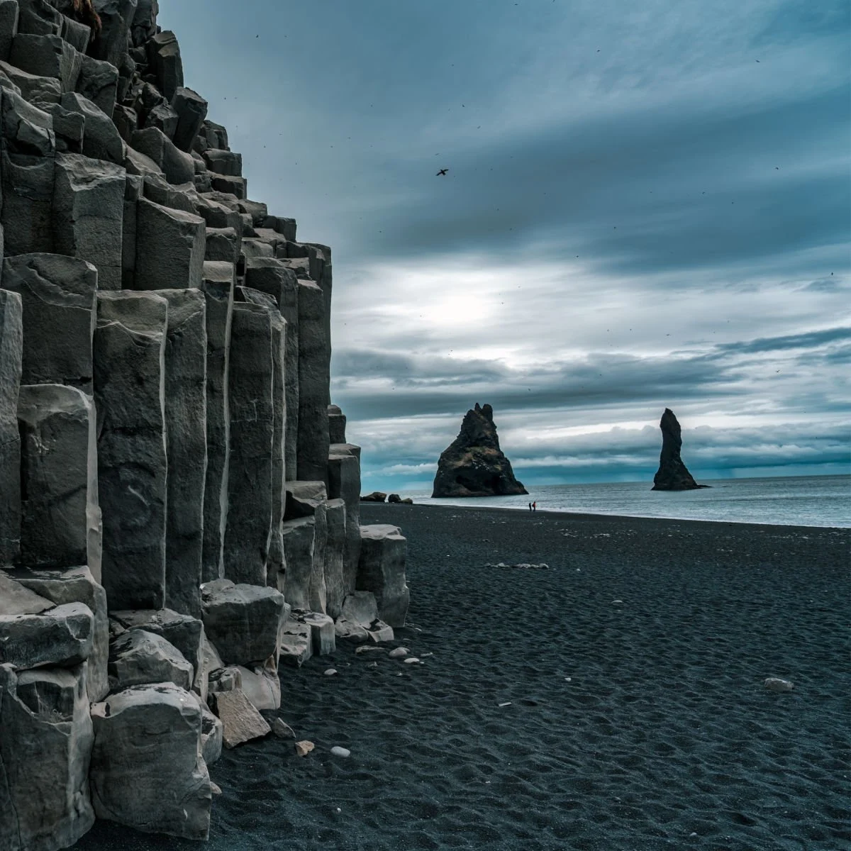 Otherworldly rock formations on black sand beach in Iceland