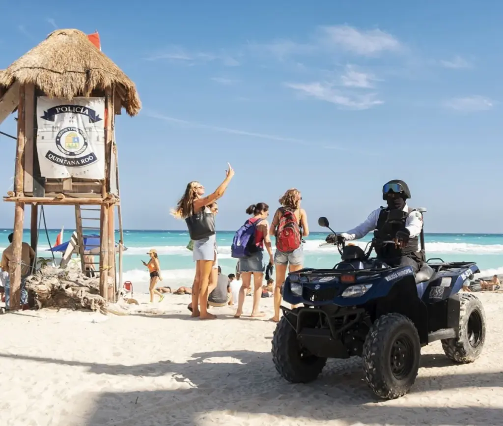 Police Officer On Cancun Beach Tourist waving