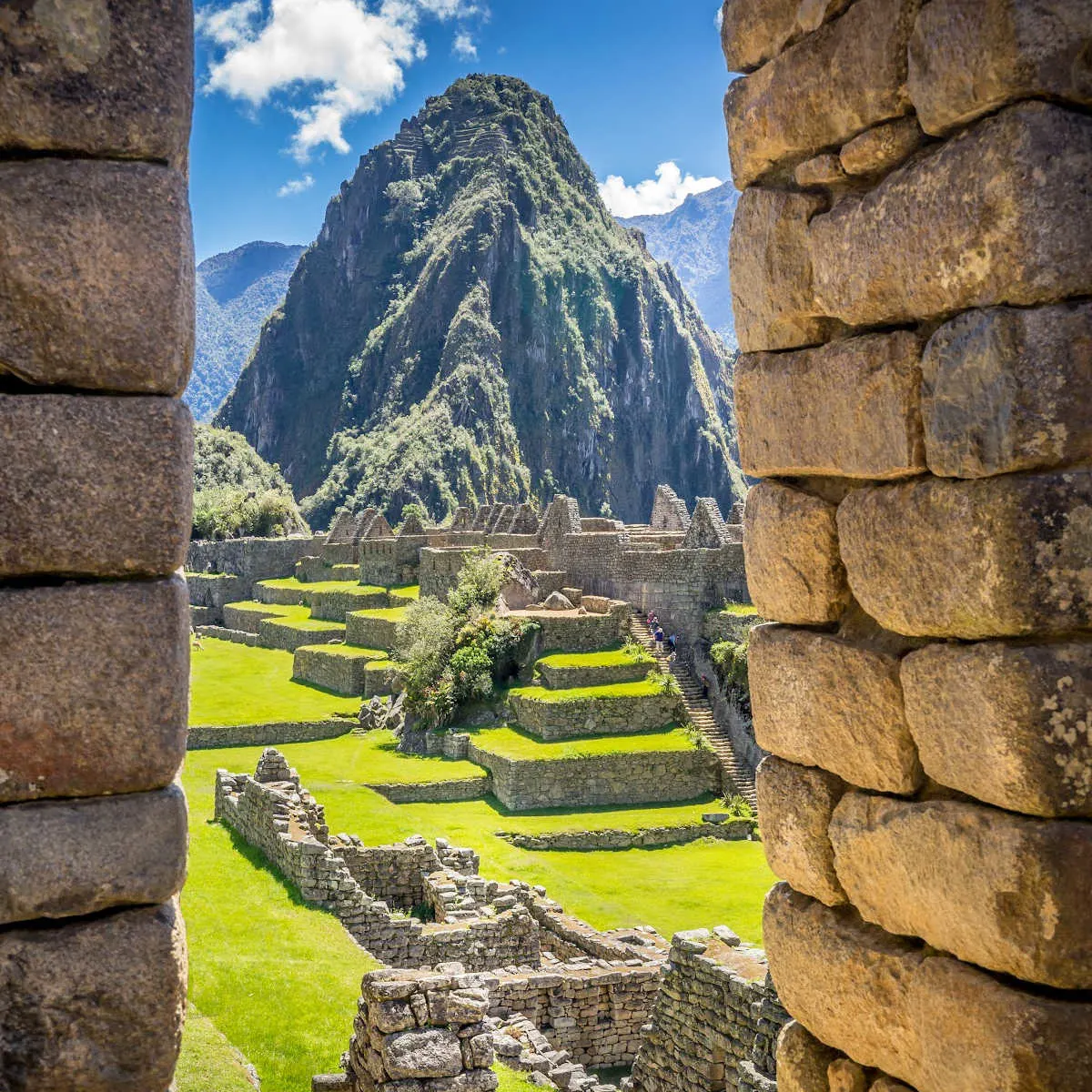View of Machu Picchu through stone wall