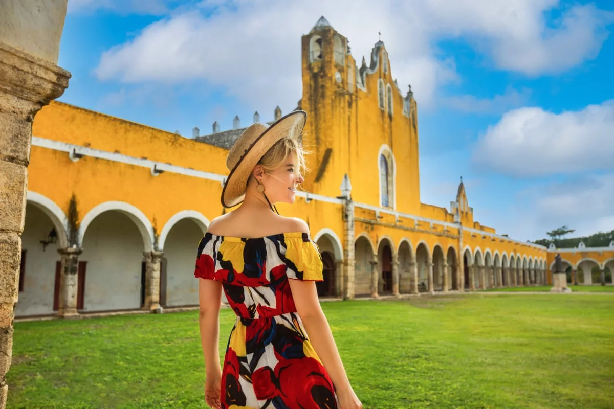 Woman in Izamal, Mexico with yellow building in the background