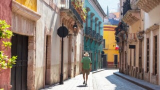 Man walking through colorful street in Guanajuato, Mexico