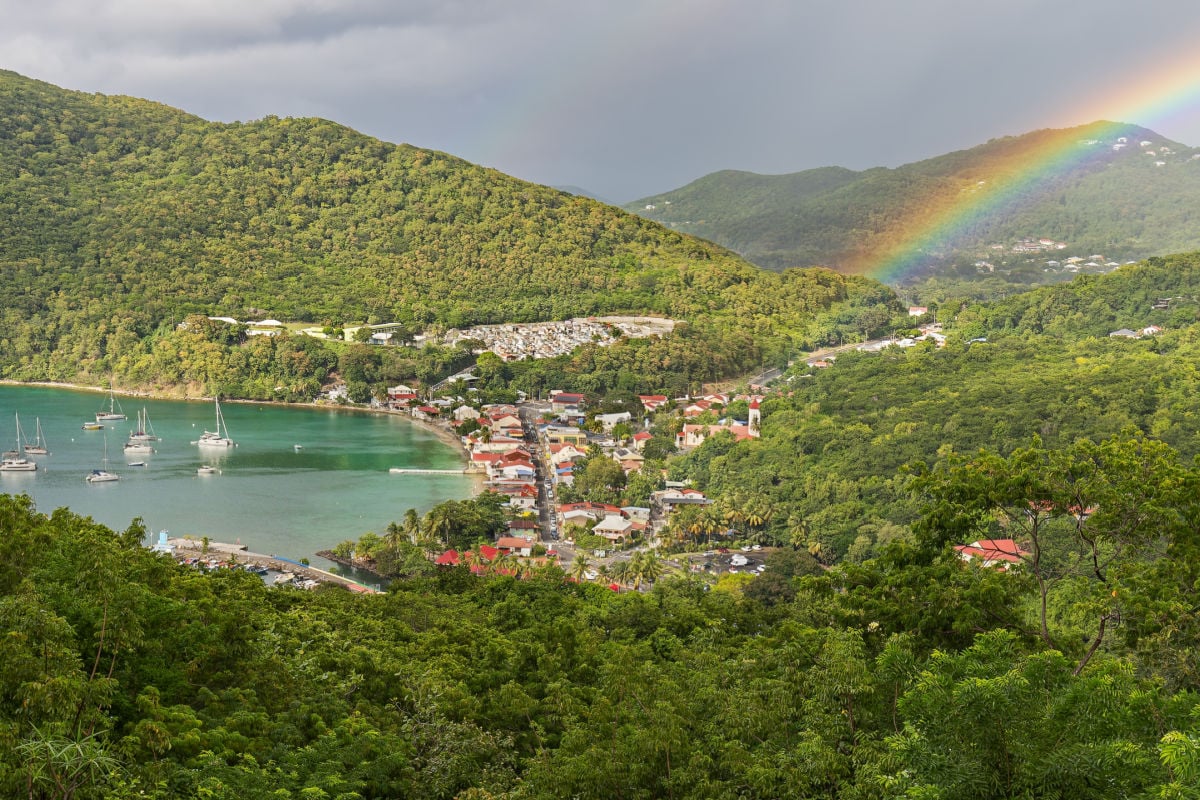 Small town Deshaies (Caribbean island Guadeloupe) at late afternoon with rainbow