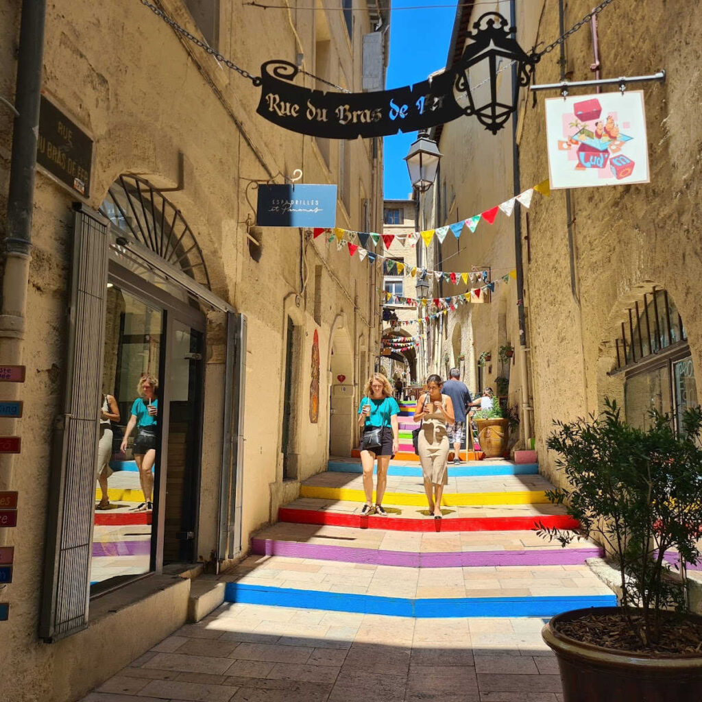 Tourists walking through colorful walkway in Montpelleir, France