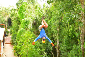 Tyler Fox upside down on zipline with Extreme Adventuring Cancun