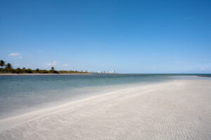 White-sand beach with Miami skyline in the distance