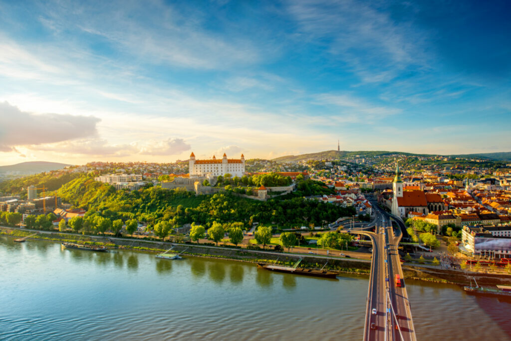 Bratislava aerial cityscape view on the old town with Saint Martin's cathedral, castle hill and Danube river on the sunset in Slovakia. Wide angle view with copy space