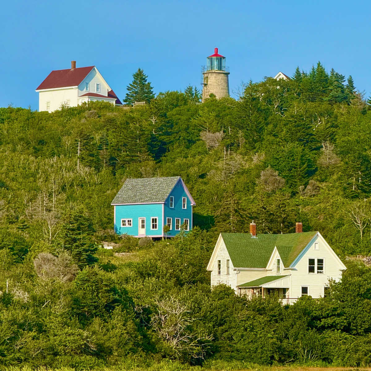 Hillside cottages and lighthouse on Monhegan Island, Maine