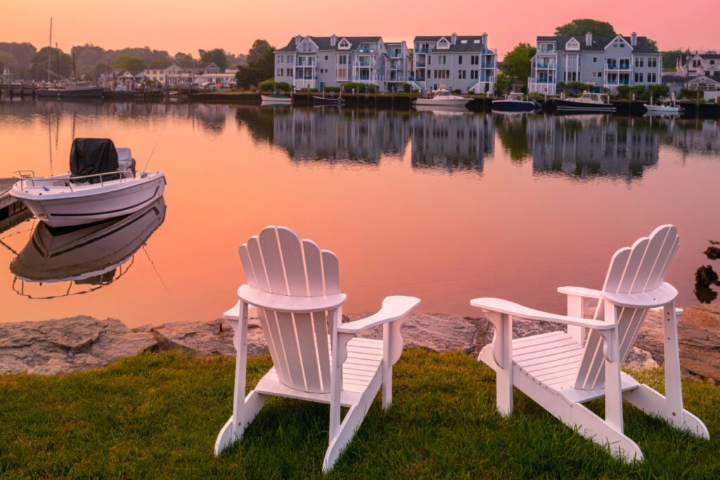 Adirondack chairs along waterfront of Mystic, CT