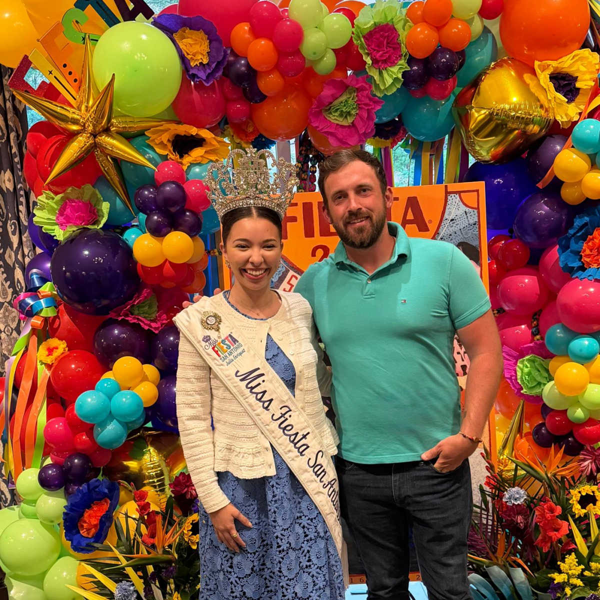 Travel Off Path Journalist Sam Sears posing with Miss Fiesta in San Antonio
