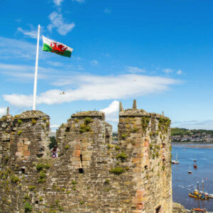 Wales flag atop stone castle
