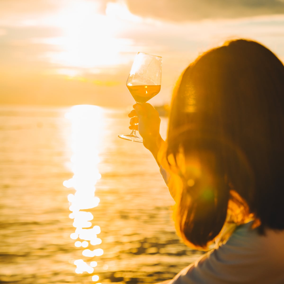 Woman with wine at beach