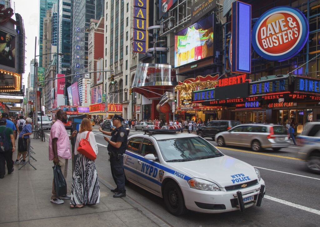 Police talk with tourists in Time Square New York