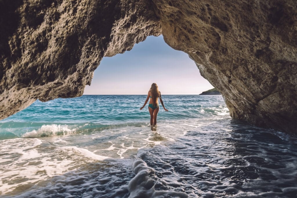Female beachgoer in sea cave in Albania