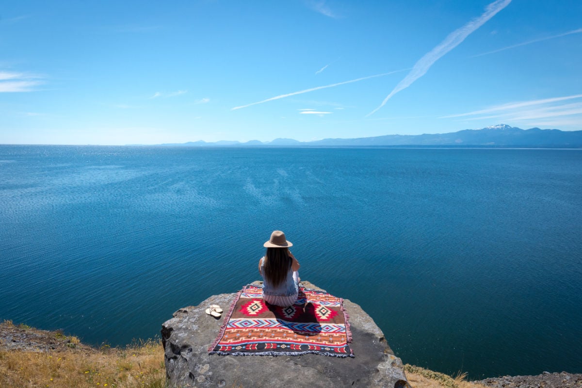 Tourist on blanket at Hornby Island, Canada