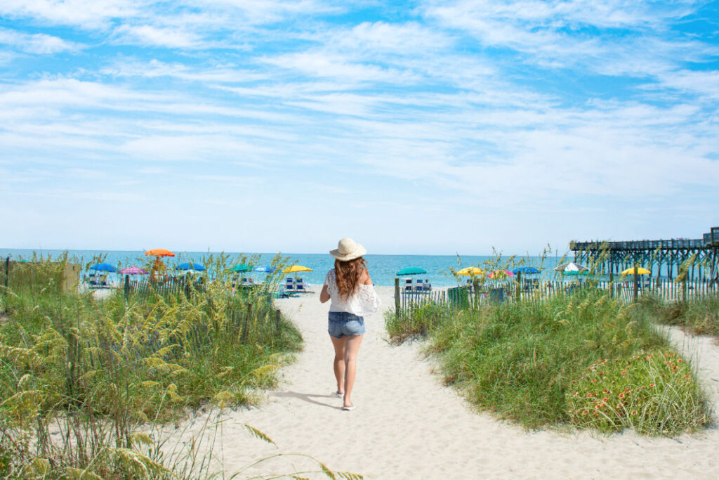 Woman walking toward beach in Myrtle Beach, SC