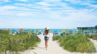 Woman walking toward beach in Myrtle Beach, SC