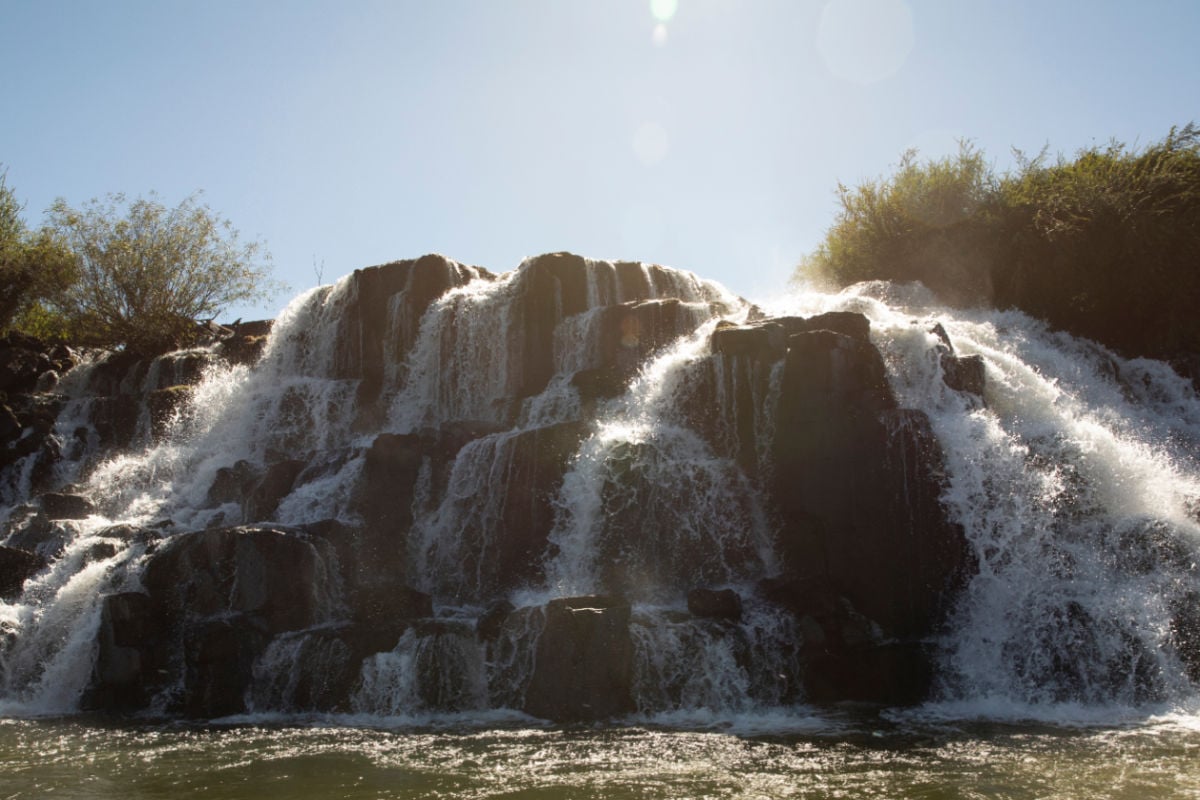Majestic view of the Mocona falls. The Moconá waterfalls, river and rocky cliffs in a summer sunny day in Misiones, the frontier between Argentina and Brazil.