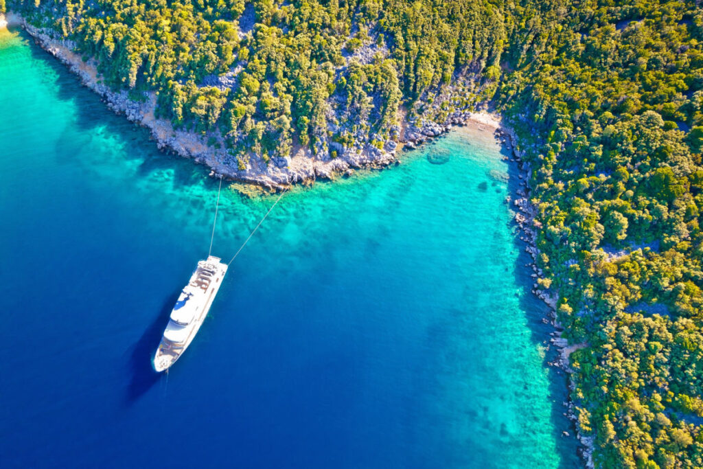 Aerial view of yacht on vibrant blue waters of Mali Losinj, Croatia