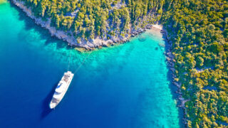 Aerial view of yacht on vibrant blue waters of Mali Losinj, Croatia