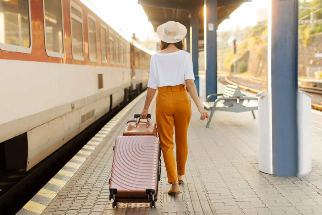 Woman with luggage at train station