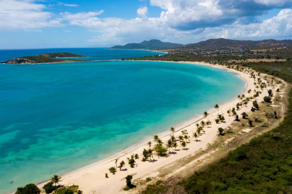 Beautiful Sun Bay beach with small fishing boats and people relaxing located on the tropical Caribbean island of Vieques Puerto Rico