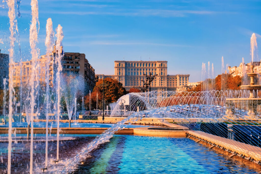 Famous building of Parliament house in Bucharest, the bigest landmark of Romania near the new fountains of capital.