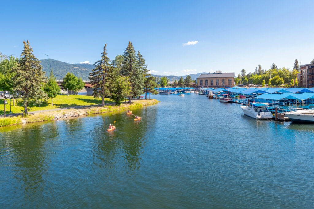 Kayakers enjoy a sunny summer day on Sand Creek alongside the marina and downtown at Lake Pend Oreille in Sandpoint, Idaho.