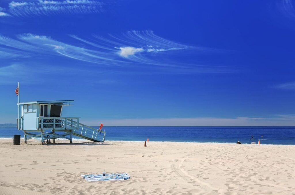 Los Angeles Beach With Lifeguard Tower And American Flag
