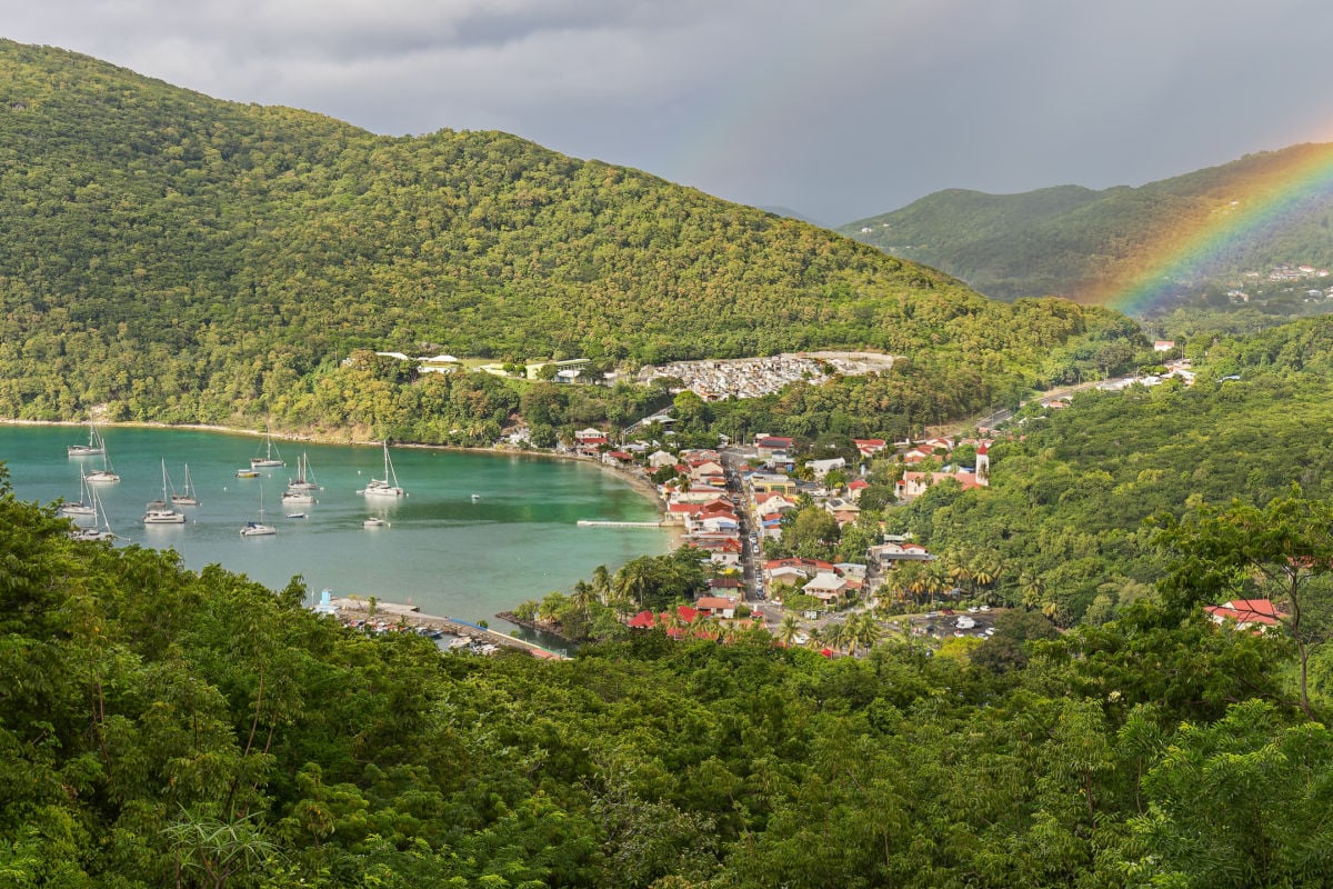 Small town Deshaies (Caribbean island Guadeloupe) at late afternoon with rainbow